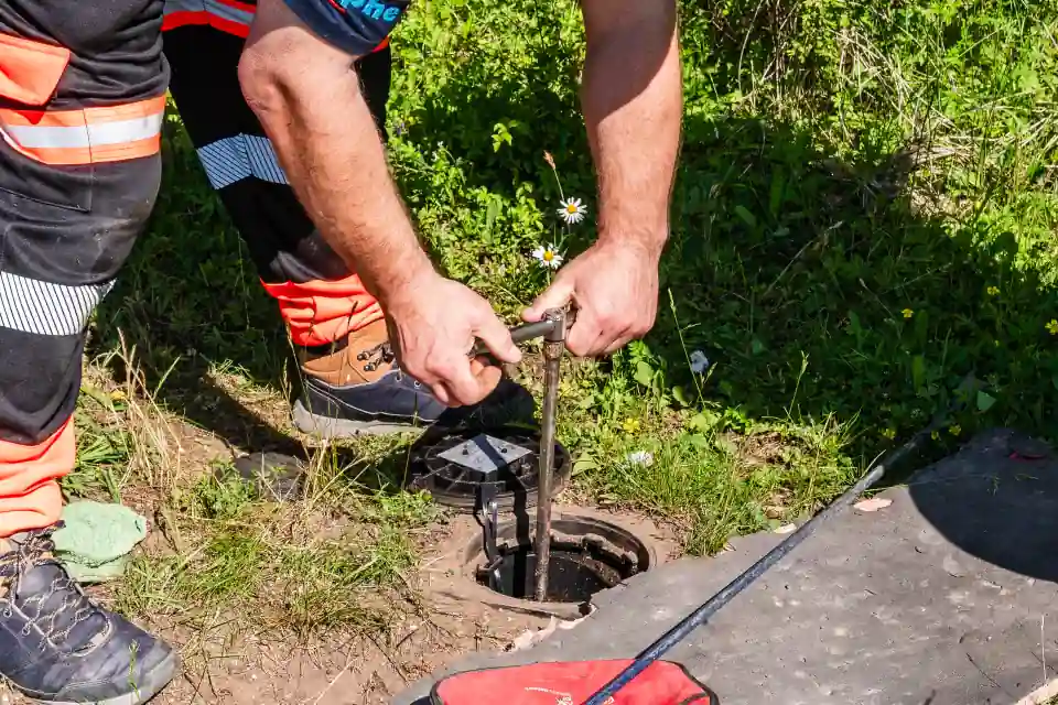 ADI engineer operating an external stop tap at a boundary box to test a water supply pipe